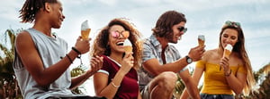 a group of young adults eating ice cream cones